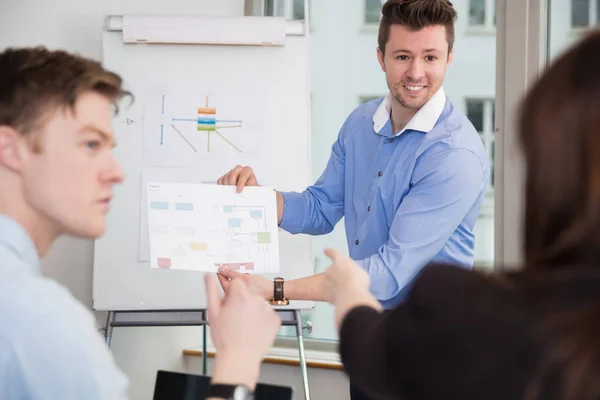 Smiling Professional Showing Chart To Colleagues — Stock Photo, Image