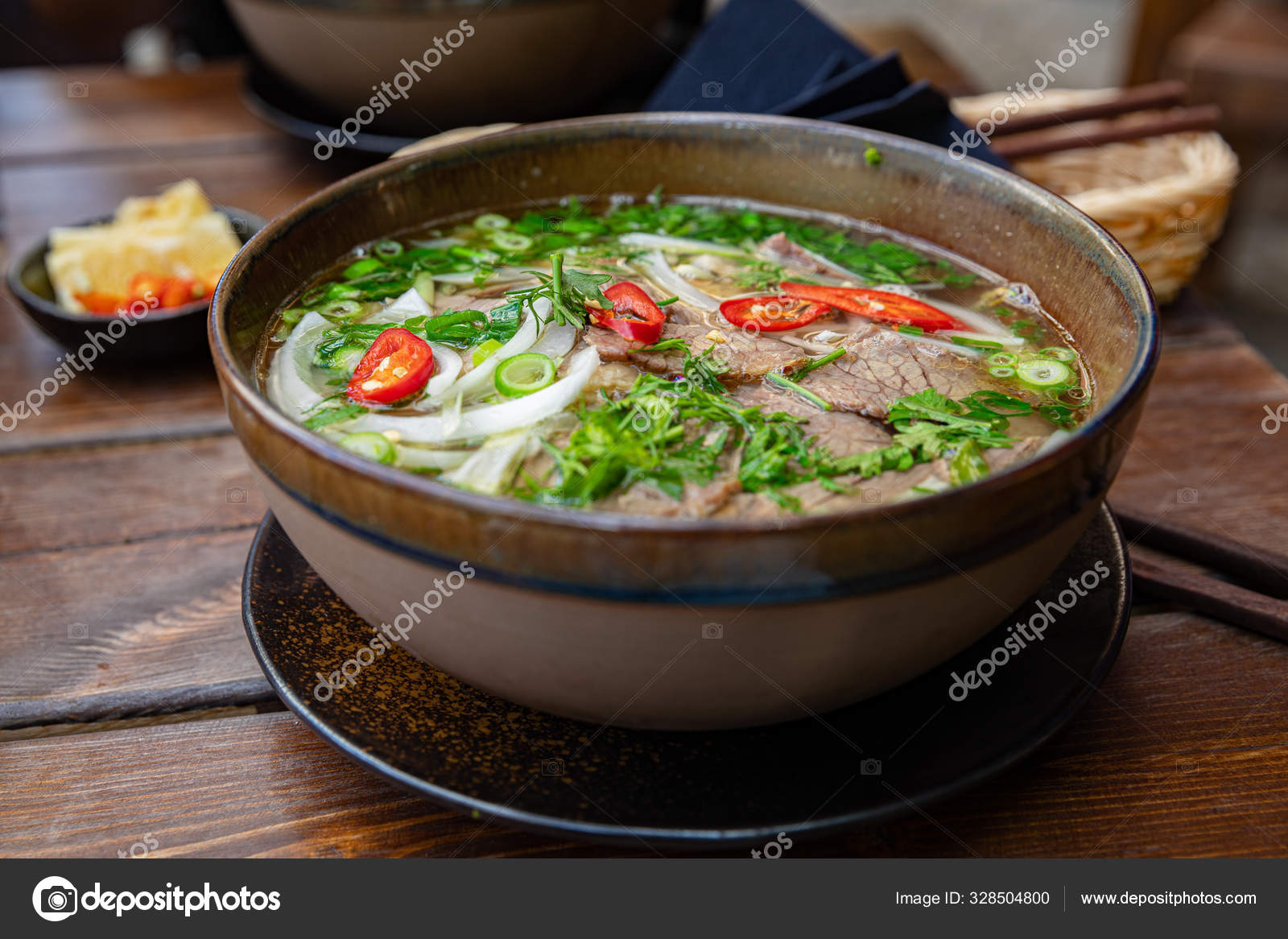 Close-up of fresh Pho soup in bowl served on table Stock Photo by