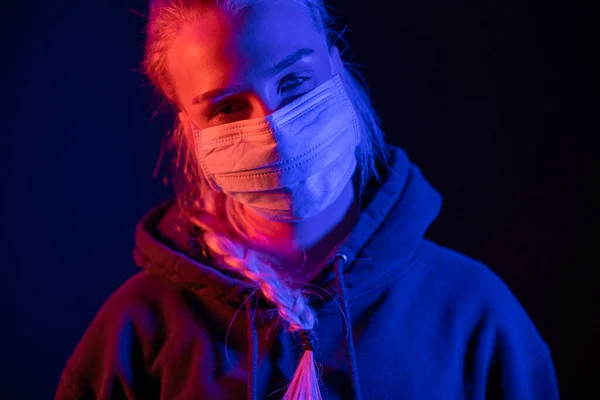 Exhausted or sick woman in protective face mask with multi colored lights — Stock Photo, Image