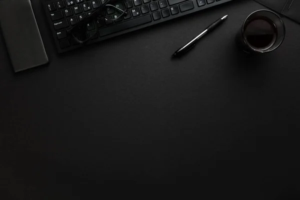 灰色办公桌上装有钢笔、智能手机和眼镜的计算机键盘 — 图库照片
