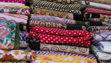 Beyaz arka planda renkli banyo havluları yığını. Gökkuşağı renkli havlular izole edildi. Üst görüş. Hijyen, kumaş, spa ve tekstil konsepti.