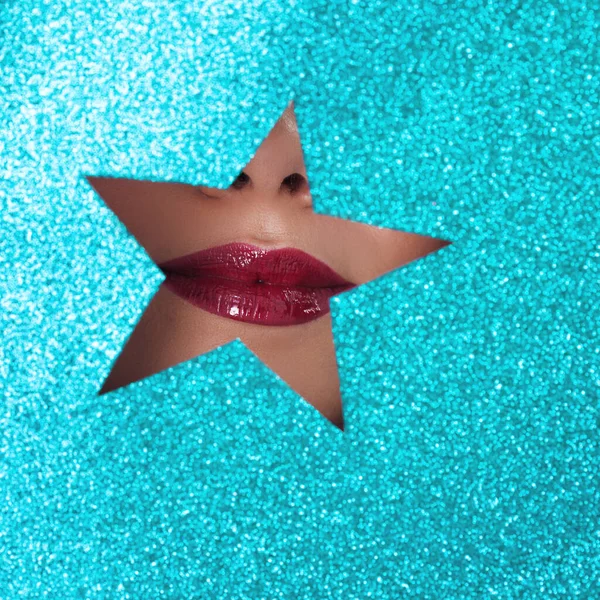 Women\'s lips with red lipstick in a star-shaped cutout. Glamorous lip
