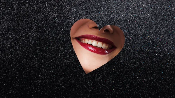 Uśmiechnięte kobiece usta z czerwoną szminką w kształcie serca. — Zdjęcie stockowe