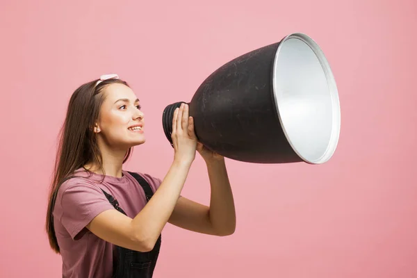 young activist shouts into a megaphone, a young girl in a jumpsuit