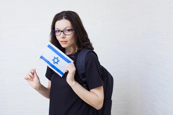 Юна жінка з окулярами тримає прапор Ізраїлю.. — стокове фото