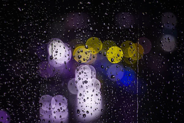 Rain drops on the window with traffic bokeh light — Stock Photo, Image