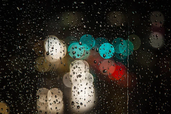 Rain drops on the window with traffic bokeh light — Stock Photo, Image