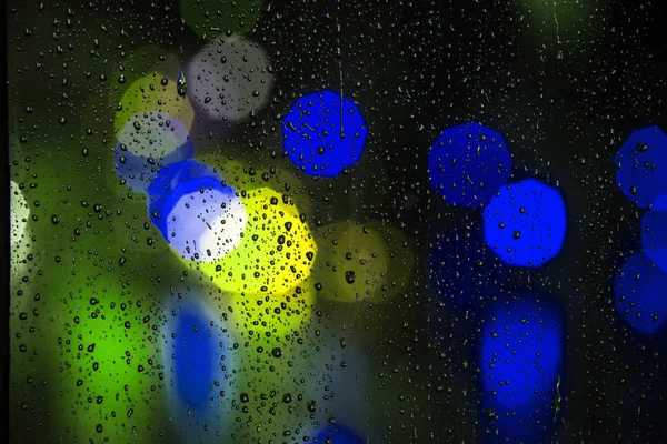 Rain drops on the window with traffic bokeh light — Stock Photo, Image