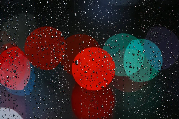 Rain drops on the window with traffic bokeh light — Stock Photo, Image