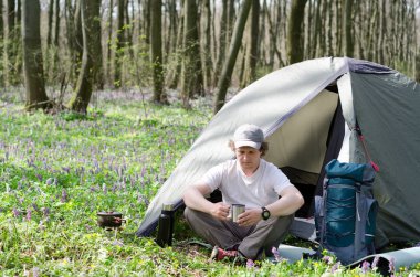 Turistik bir çadır kampında çay içer.