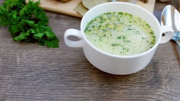 Mushroom soup with croutons in a white dish is on a wooden table. The video was filmed with Dolly. — Stock Footage Mushroom Soup Croutons White Dish Wooden Table Video Filmed Dolly Video Clip
