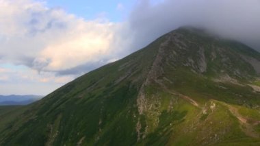 Düşük güneş ışınlarının en yüksek dağ Zirvesi bulutlar kaplı. Zaman atlamalı.