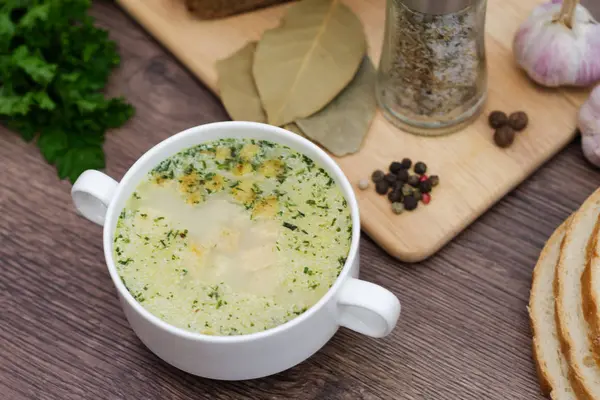 Mushroom soup with croutons in a white dish is on a wooden table — Stock Photo, Image