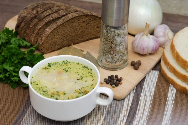Грибной суп с гренками в белом блюде на деревянном столе — стоковое фото