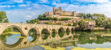 Panoramic view at the Old Bridge over Orb river with Cathedral of Saint Nazaire in Beziers - France clipart
