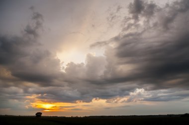 Fırtına bulutları bir arka plan üzerinde gün batımı. Yağmurlu hava.