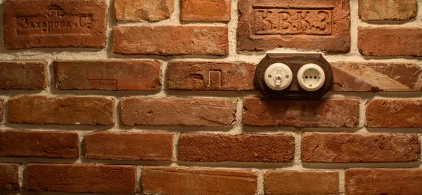 Socket and switch on a brick wall