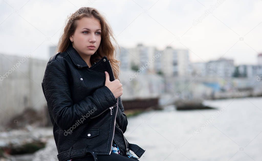 Sad young girl in the background of the city