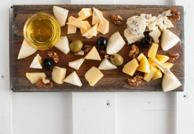 Peynir bal ve fındık ile çeşitli çeşitli. Bir koyu ahşap tahta üzerine yerleştirilmiş