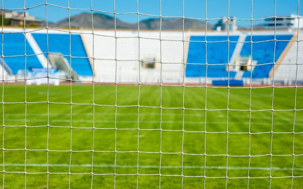 View of the sports stadium through the net of the football goal Royalty Free Stock Images