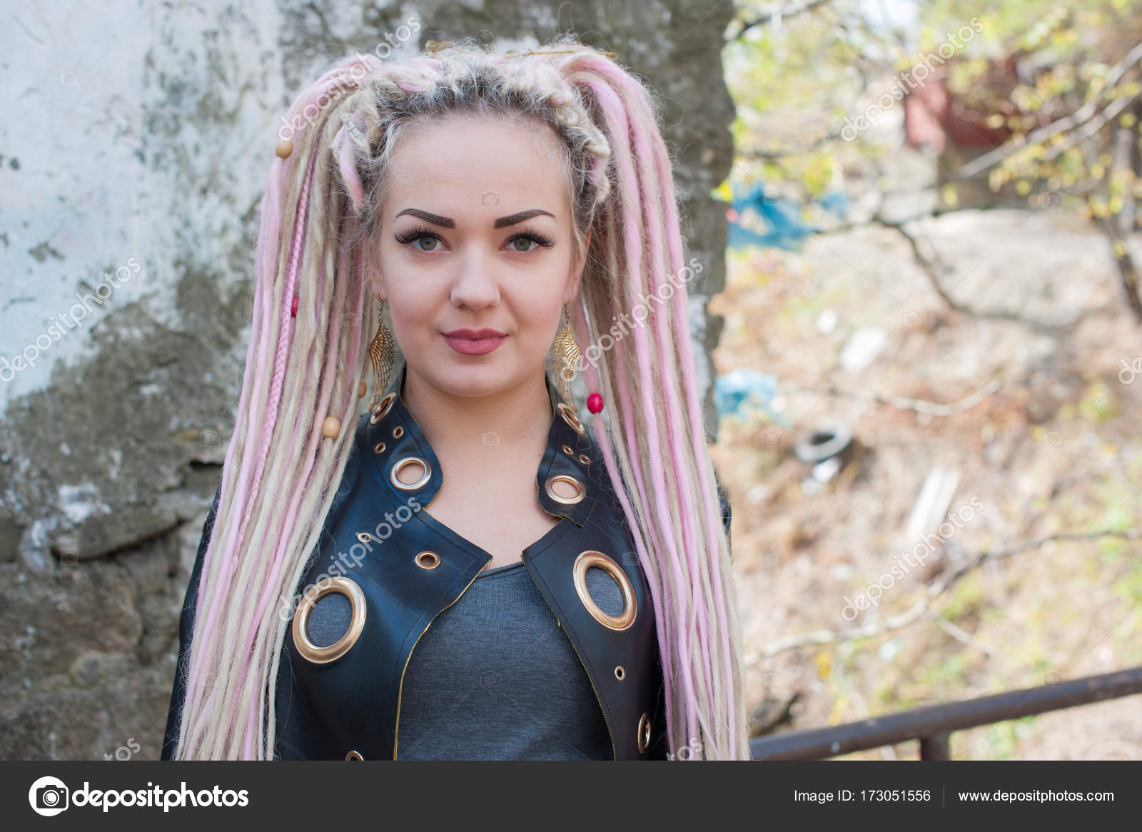 A Girl With Dreadlocks In A Leather Jacket And A Short Skirt