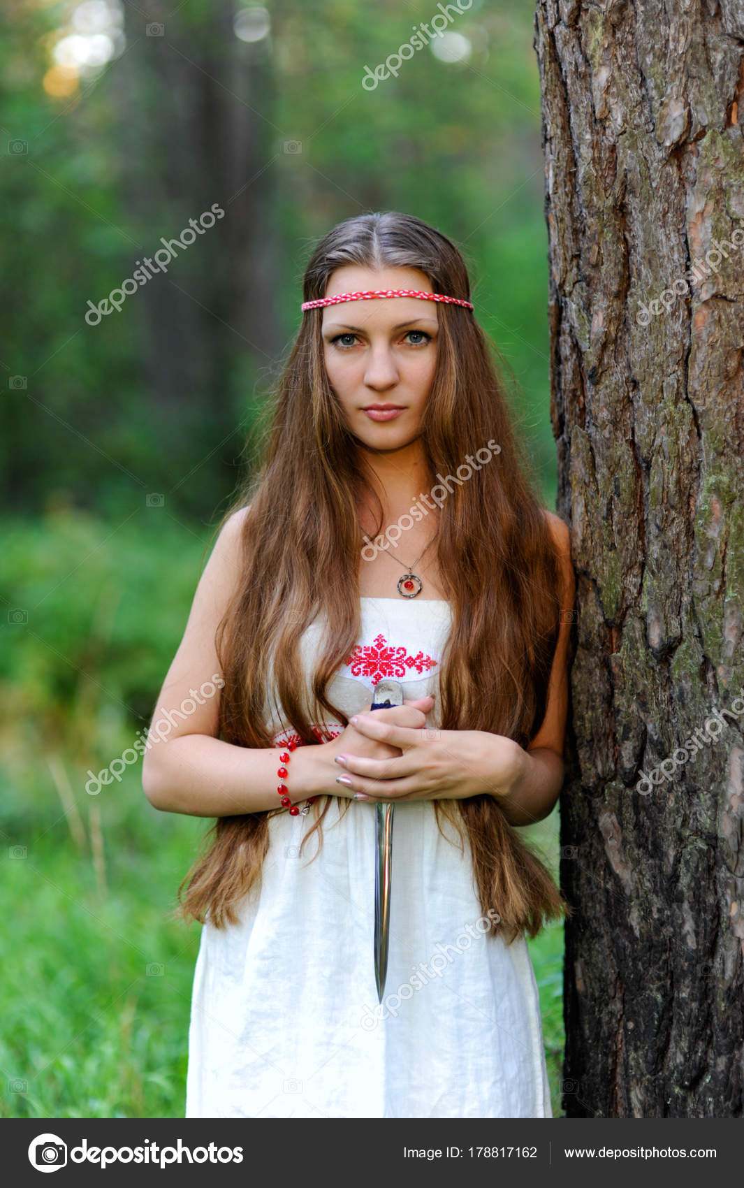 Portrait of a Young Beautiful Slavic Girl with Long Hair and a Slavic Ethnic  Dress on a Background of Green Grass Stock Photo - Image of fairy, beauty:  106909634