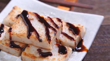 Lezzetli şalgam kekinin üzerine kara soya sosu dök restoranda geleneksel Çin turplu keki, kapat, uzayı kopyala.