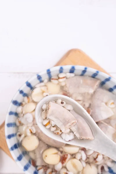 Tasty Four Tonics Herb Flavor Soup,Taiwanese traditional food with herbs,pork intestines on white wooden table,close up,flat lay,top view