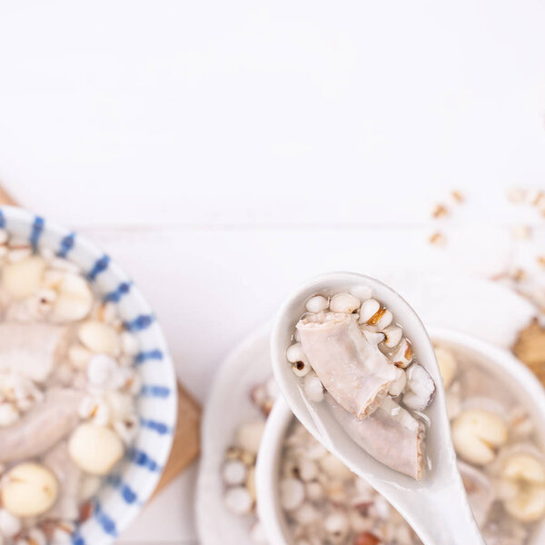 Tasty Four Tonics Herb Flavor Soup,Taiwanese traditional food with herbs,pork intestines on white wooden table,close up,flat lay,top view