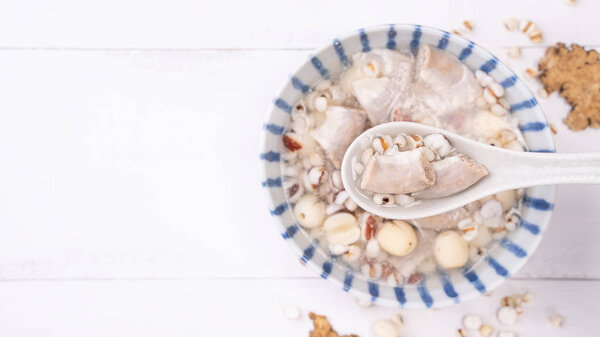 Tasty Four Tonics Herb Flavor Soup,Taiwanese traditional food with herbs,pork intestines on white wooden table,close up,flat lay,top view