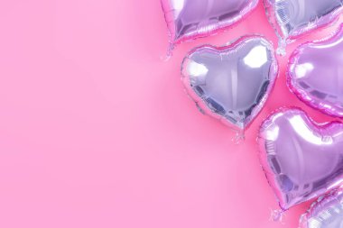 Sevgililer Günü asgari tasarım konsepti - soluk pembe arka planda izole güzel kalp şeklinde folyo balon, üst görünüm, düz yatış, yukarıdaki fotoğrafçılık.