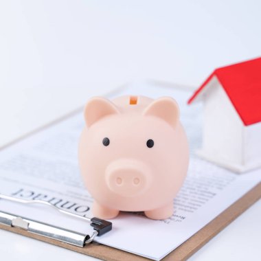 Finansal kuruluş - domuz kumbarası, beyaz arka planda güzel kırmızı beyaz ahşap ev modeli, sigorta almak için para biriktirme, kapama, yer kopyalama.