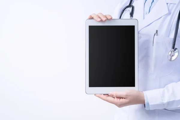 Doctor with stethoscope in white coat holding tablet, showing medical information, diagnosis, isolated on white background, close up, cropped view.