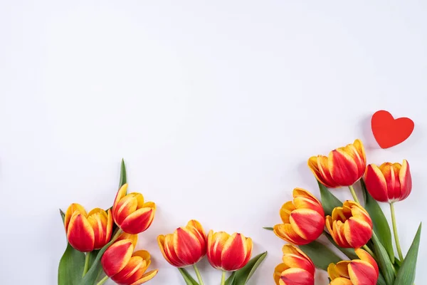 Mother\'s Day, Valentine\'s Day background, tulip flower bunch - Beautiful Red, yellow bouquet isolated on white table, top view, flat lay, mock up design concept.