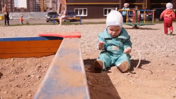Baby Toddler Playing Sand Sandbox Rakes His Hands — Stock Video