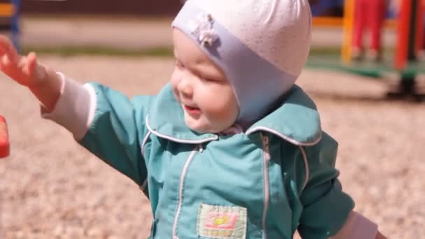 Baby Toddler Playing Sand Sandbox Rakes His Hands — Stock Video