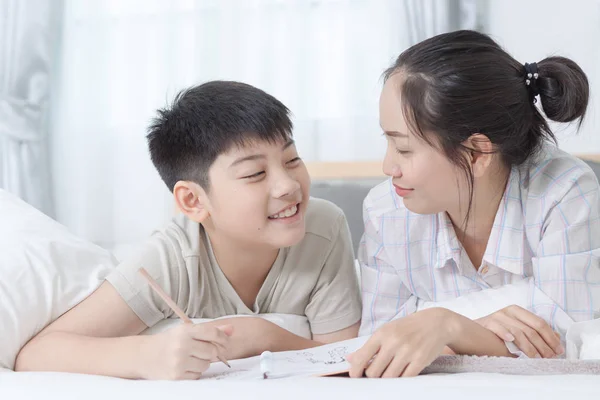 Sister helping brother to writing homework — Stock Photo, Image