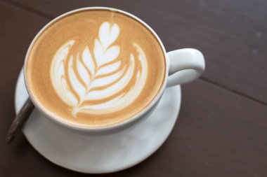 Latte sanat sıcak kahve kahve dükkanında masada.