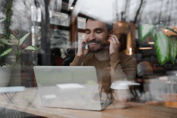 Adult bearded business man with laptop in cafe , modern digital technologies and fast internet.