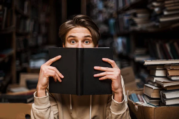 Stunned Guy Hiding Book Peeps Out Surprised Shocked Eyes New — Stock Photo, Image