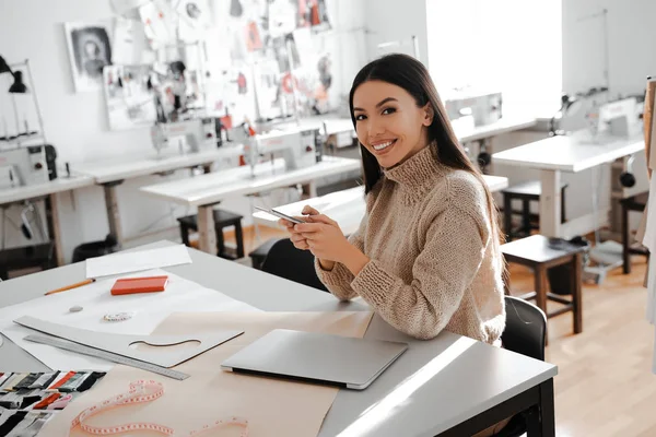 Business woman asian professional tailor organized her own dressmaker school, happy freelance work, expert and leader in her sphere. Planning future projects. Workplace in studio. People lifestyle.