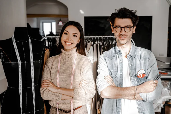 Tailoring, dressmaking, designer sphere. Two creative creative people, a man and a woman of different nationalities and races, met to exchange experiences in their favorite business.