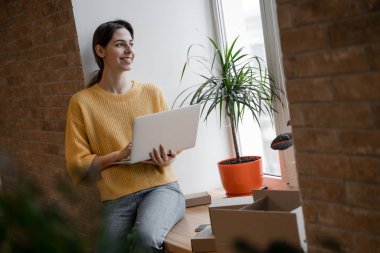 Kadın dizüstü bilgisayarla çalışmaya odaklanmış. İnternet üzerinden satış yapan küçük bir işletme sahibi. Çevrimiçi Satış, E-Ticaret, E-İş, posta paketi, online satış, dağıtım konsepti.