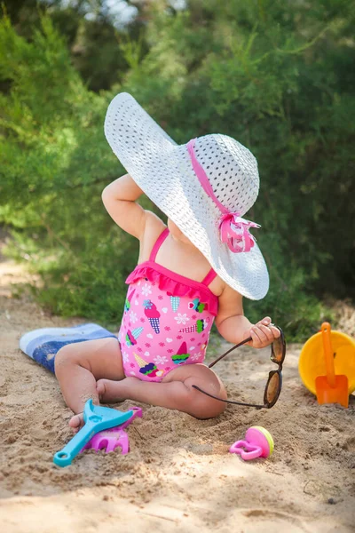 Baby girl playing on beach. Stock Photo
