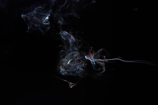 Freeze motion of smoke on black background. Abstract vape clouds.