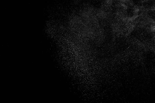 Заморожування руху білих частинок на чорному тлі . — стокове фото