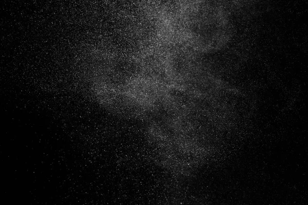 Congelar o movimento de partículas brancas sobre fundo preto . — Fotografia de Stock