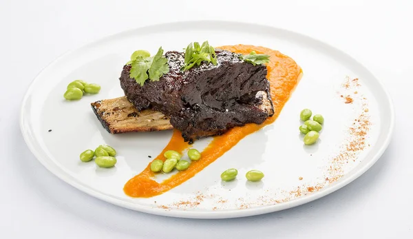 Pork rib with sauce on a white plate — Stock Photo, Image