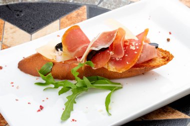 Prosciutto ve roka ile beyaz tabakta