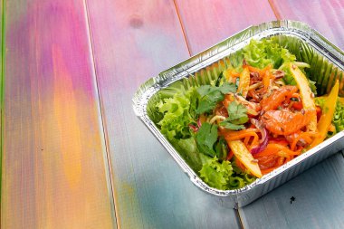 Renkli arka planda ızgara sebzeli ve greyfurtlu salata. Paket servis. Diyet ve sağlıklı yiyecekler.